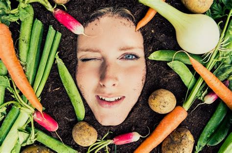 a woman s face surrounded by vegetables and potatoes