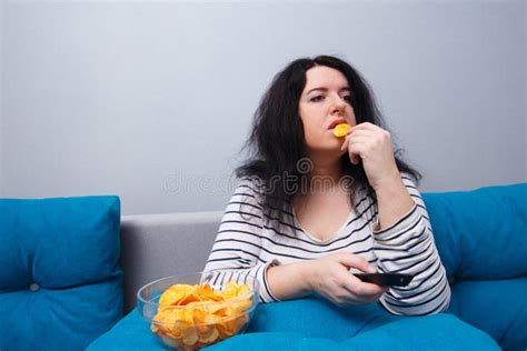 Fat Overweight Woman Sitting On The Sofa Eating Chips While Wat Stock Image Image Of Health