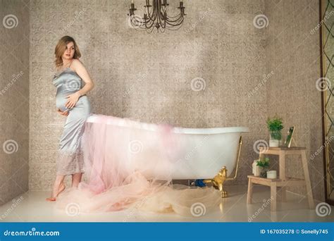 Pregnant Woman In The Bathroom Close Up Pregnant Near The Bath In A