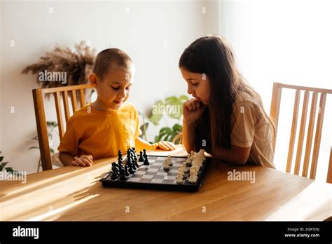 Cute Kids Playing Chess At Home Stock Photo Alamy