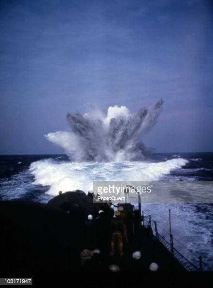 Sailors Stand On Deck And Watch As A Depth Charge Explodes In The