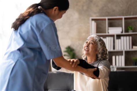 Young Caregiver Helping Senior Woman Walking Nurse Assisting Her Old