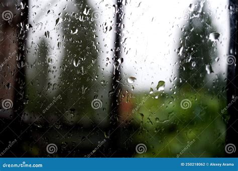 Raindrops On The Window Pane With Blurred Background Stock Photo