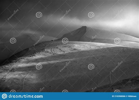 Grayscale Snow Covered Mountain Slope In Last Evening Sunlight Stock