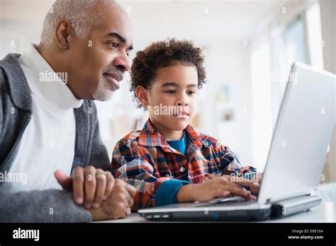 Mixed Race Grandfather And Grandson Using Laptop Stock Photo Alamy