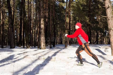 Winter Trail Running Man Takes A Run On A Snowy Mountain Path In A