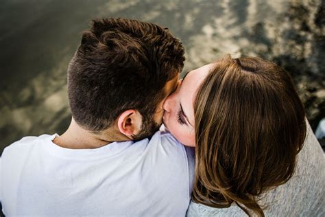 Couple Kisses On A Dock During Their Lake House Engagement Session Fall Engagement Engagement