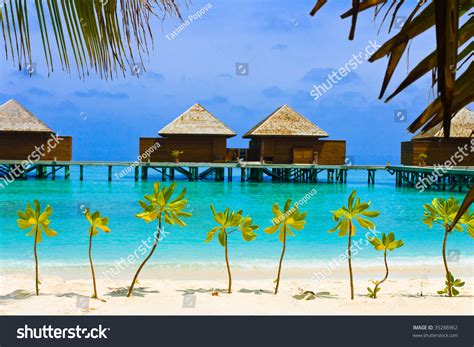 Water Bungalows On Tropical Island Vacation Stock Photo