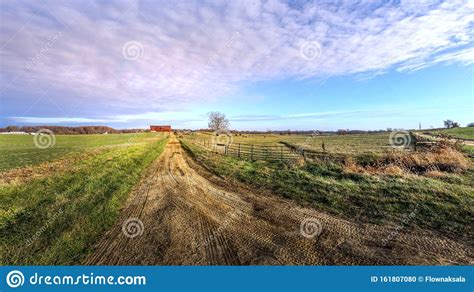 Rural Maryland Farm Landscape With Long Dirt Road Leading