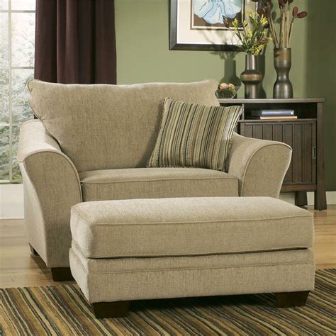 Classic Creamy Oversized Accent Chair With Stripe Patterned Cushion And Footrest On Stripe Patterned Area Rug 