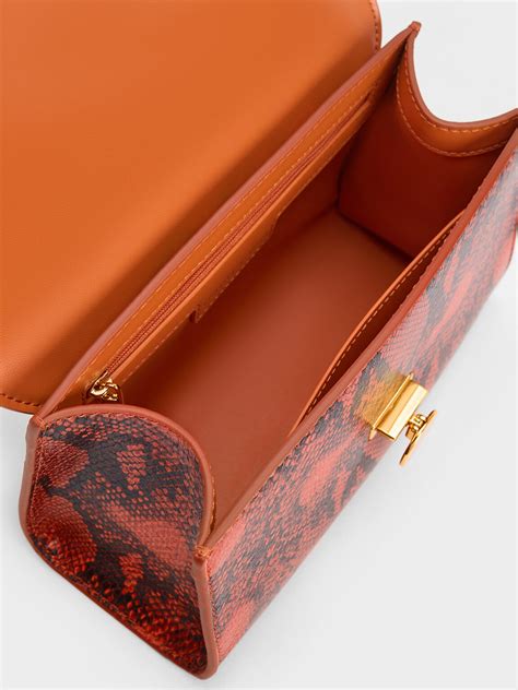 Orange Snake Print Metallic Accent Clutch Charles And Keith Pa