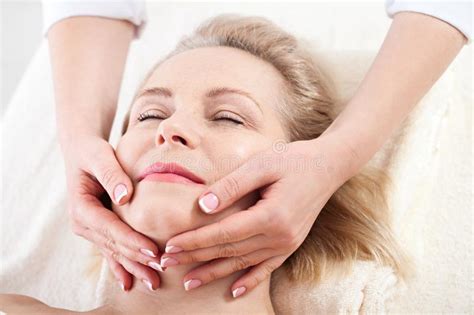 Portrait Of Beautiful Woman In Spa Environment Middle Aged Woman Doing Facial Massage In A Spa
