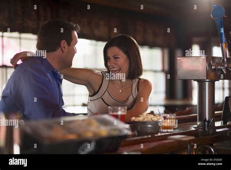 A Man And Woman Seated At A Bar Flirting And Talking On A Date New Hope Pennsylvania Usa Stock