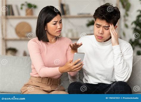 Asian Wife Kissing Husband While Daughter Royalty Free Stock Image