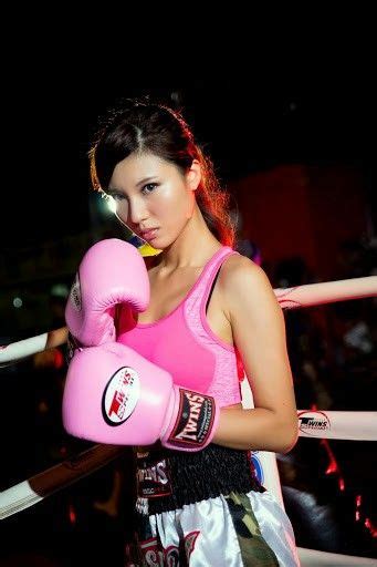 A Young Woman Wearing Pink Boxing Gloves