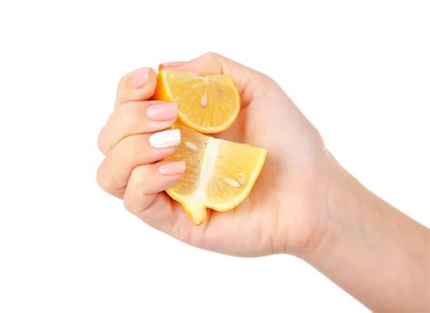 Female Hand Squeezing Lemon Isolated On White Stock Photo By