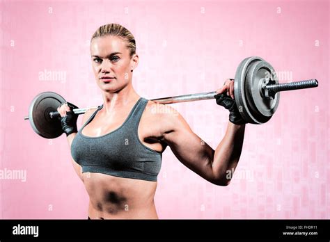 Composite Image Of Muscular Woman Lifting Heavy Barbell Stock Photo Alamy