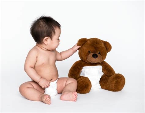 Premium Photo Baby Hugging Her Teddy Bear