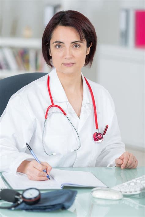 Portrait Of A Young Female Doctor Holding Medical Record With A