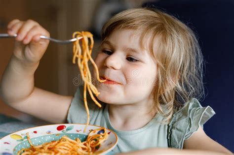 Adorable Toddler Girl Eat Pasta Spaghetti With Tomato Bolognese With