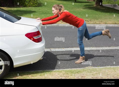 Young Woman Pushing Her Broken Down Car Stock Photo Alamy