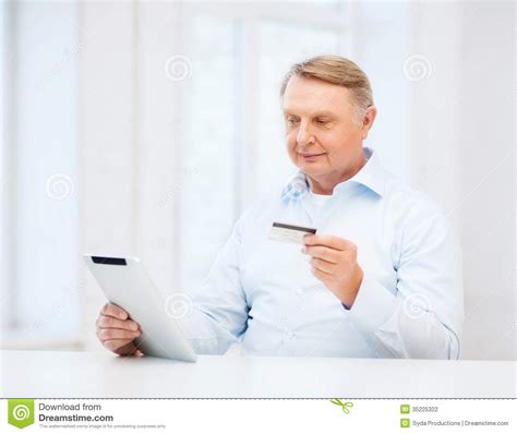 Maybe you would like to learn more about one of these? Old Man With Tablet Pc And Credit Card At Home Stock Photography - Image: 35225322