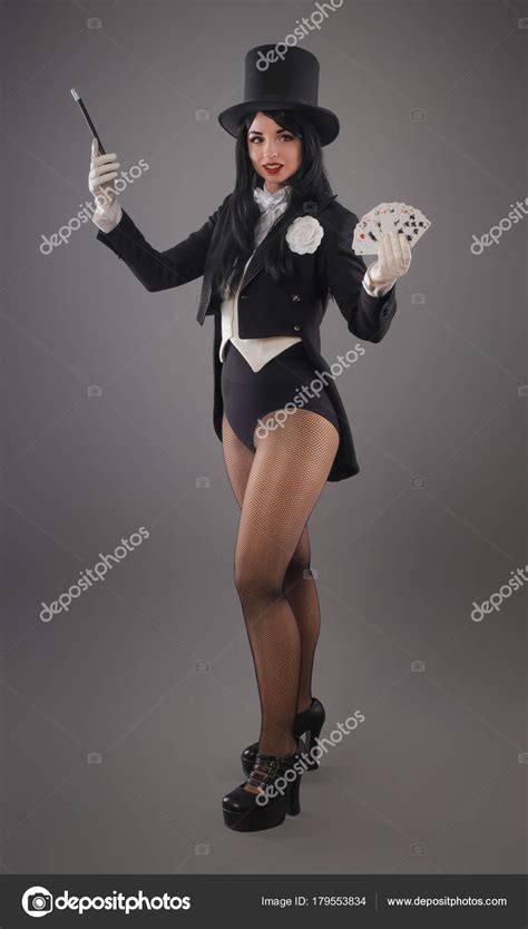 female magician in performer suit with magic wand and playing ca stock editorial photo