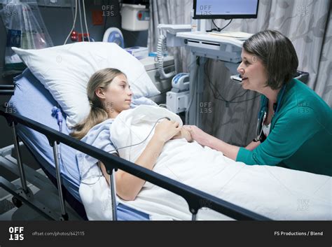 Caucasian Doctor Comforting Patient In Hospital Bed Stock Photo Offset