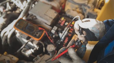 Mechanic Works With Car Electrics Electrical Wiring Voltmeter Stock