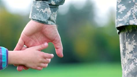Hands of father and child. Holding hands of military ...