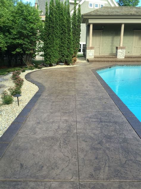 Stamped And Colored Concrete Pool Deck With Custom Chiseled Stone