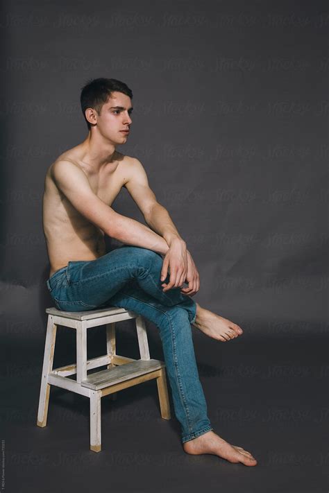 Naked Guy Sitting On Stepladder In The Studio By Stocksy Contributor Danil Nevsky Stocksy
