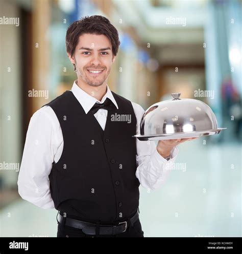 Portrait Of Young Male Waiter Holding Silver Tray Stock Photo Alamy