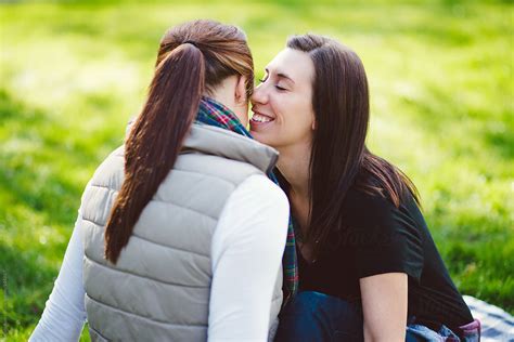 lesbian couple sitting on blanket in the park by stocksy contributor kate ames stocksy