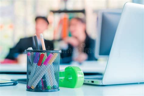 Blurred Office Worker Working In Background With Office Desk And Laptop