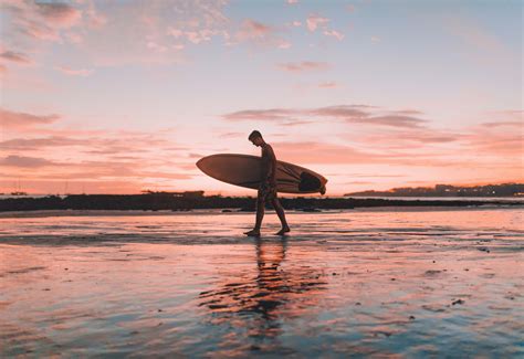 Water Man Holding Surfboard Walking Near Seashore Surfboard Image Free