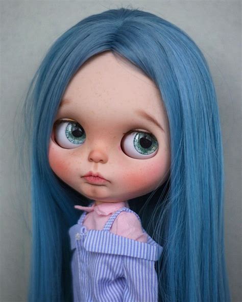 A Doll With Blue Hair And Big Eyes