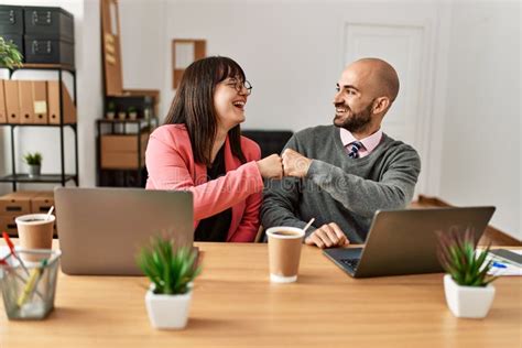 Two Hispanic Business Workers Smiling Happy Bump Fists At The Office Stock Image Image Of Bald