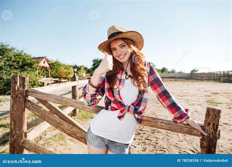 Smiling Cheerful Redhead Cowgirl In Hat Showing Thumbs Up Gesture Stock