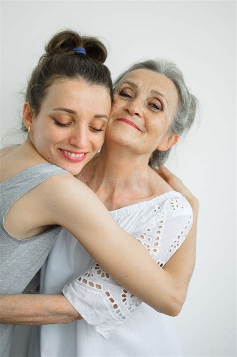 Happy Senior Mother Is Hugging Her Adult Daughter The Women Are Laughing Together Sincere