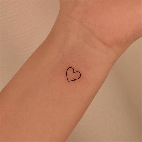 Minimalist Cross And Heart Tattoo On The Wrist