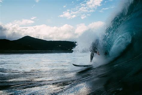 Man Surfing Blue Sky Person Surf Board Sea Waves Near Black