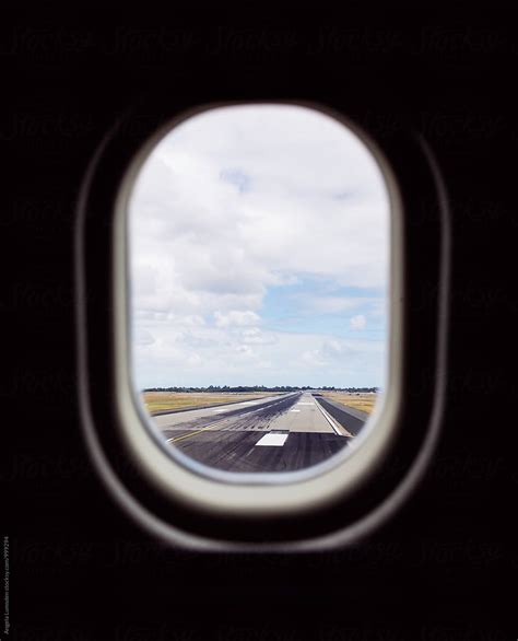 A View Of A Runway Out An Airplane Window Del Colaborador De Stocksy