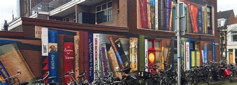 Dutch Street Artist Paints A Massive Bookcase On A Three Level Building