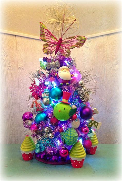 A Brightly Colored Christmas Tree Decorated With Ornaments