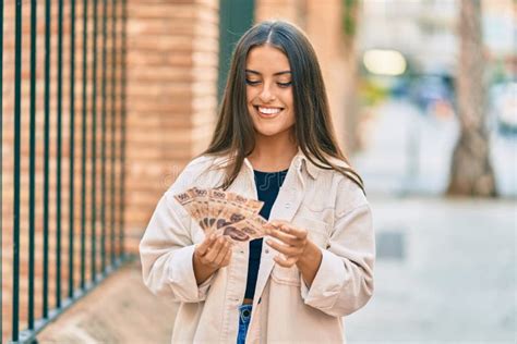 Young Hispanic Girl Smiling Happy Holding Mexican 500 Pesos Banknotes