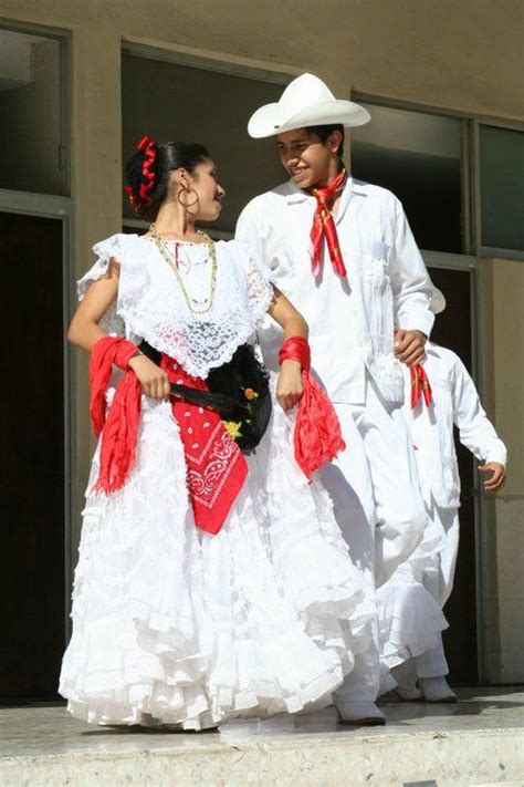 Two People Dressed In White And Red Are Walking Down The Steps Together