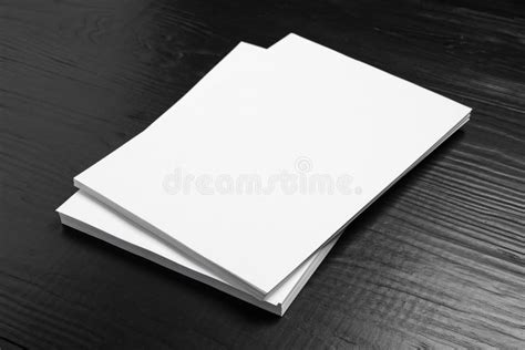 Stack Of Blank Paper Sheets For Brochure On Black Wooden Background