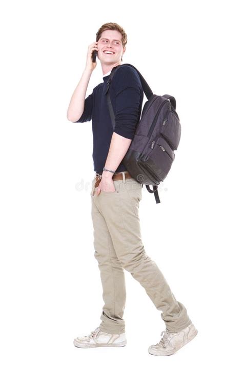 Male Student Walking On Isolated White Background With Bag And Mobile