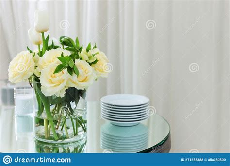 White Roses In A Vase There Is A Vase Of Flowers On The Table A Set